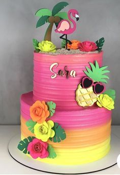 a colorful cake decorated with flowers and a flamingo