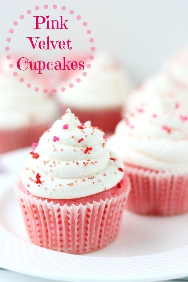 pink velvet cupcakes with white frosting and sprinkles