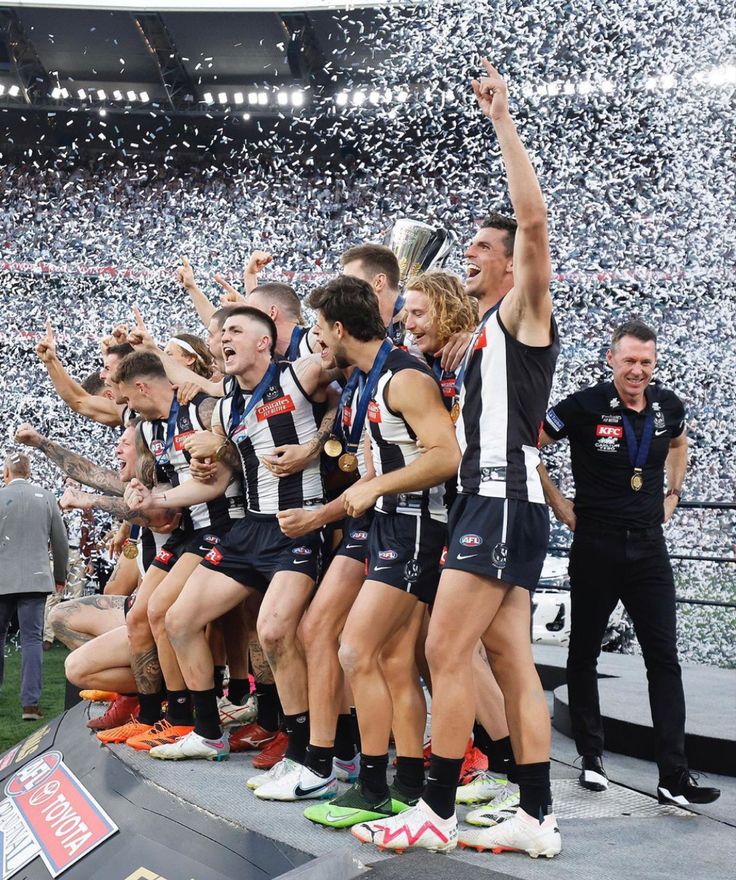 the afl women's football team celebrates with their trophy