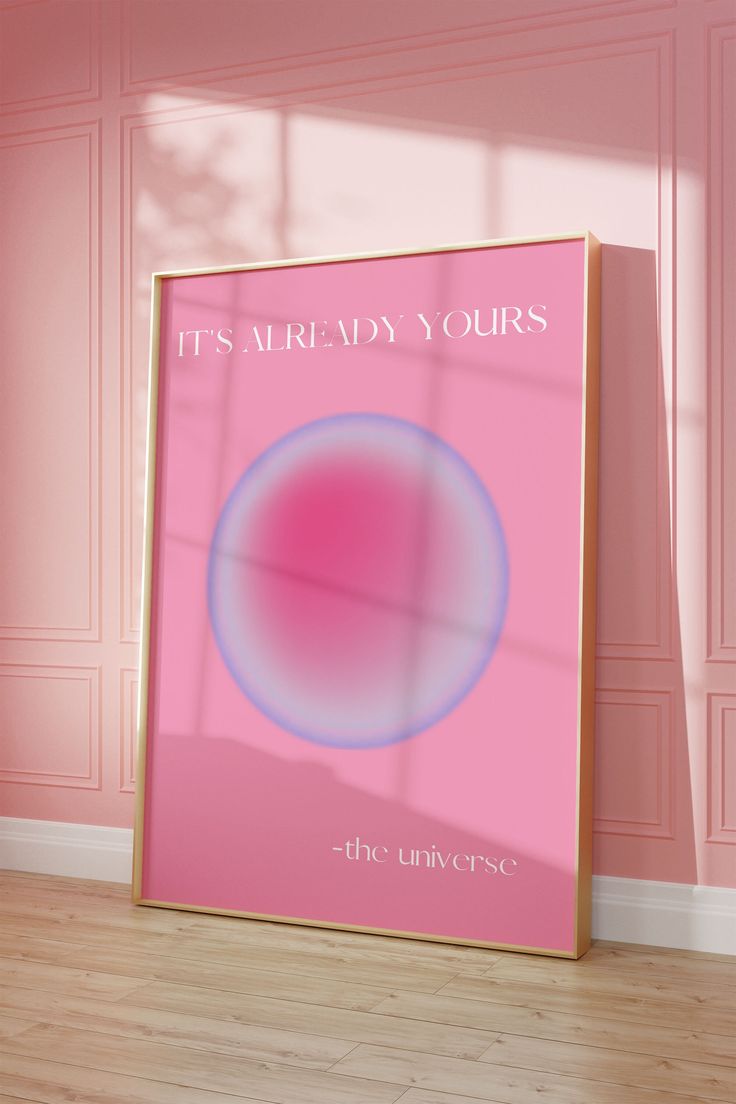 a pink poster with the words it's already yours on it in an empty room