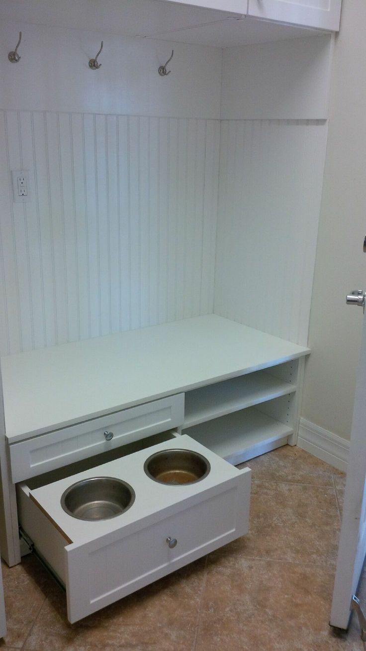 an empty white cabinet with two bowls in it