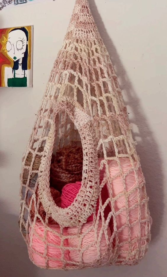 a pink bag hanging from the side of a wall