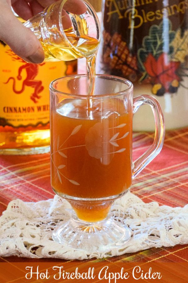 a person pours tea into a glass mug