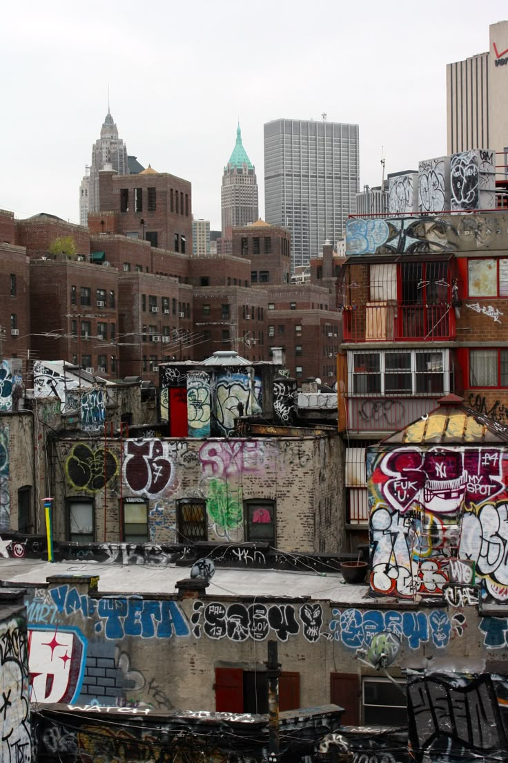 the city skyline is covered in graffiti and old buildings