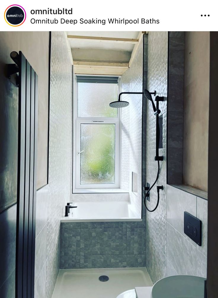 a bathroom with a window, sink and toilet in it's shower stall is shown