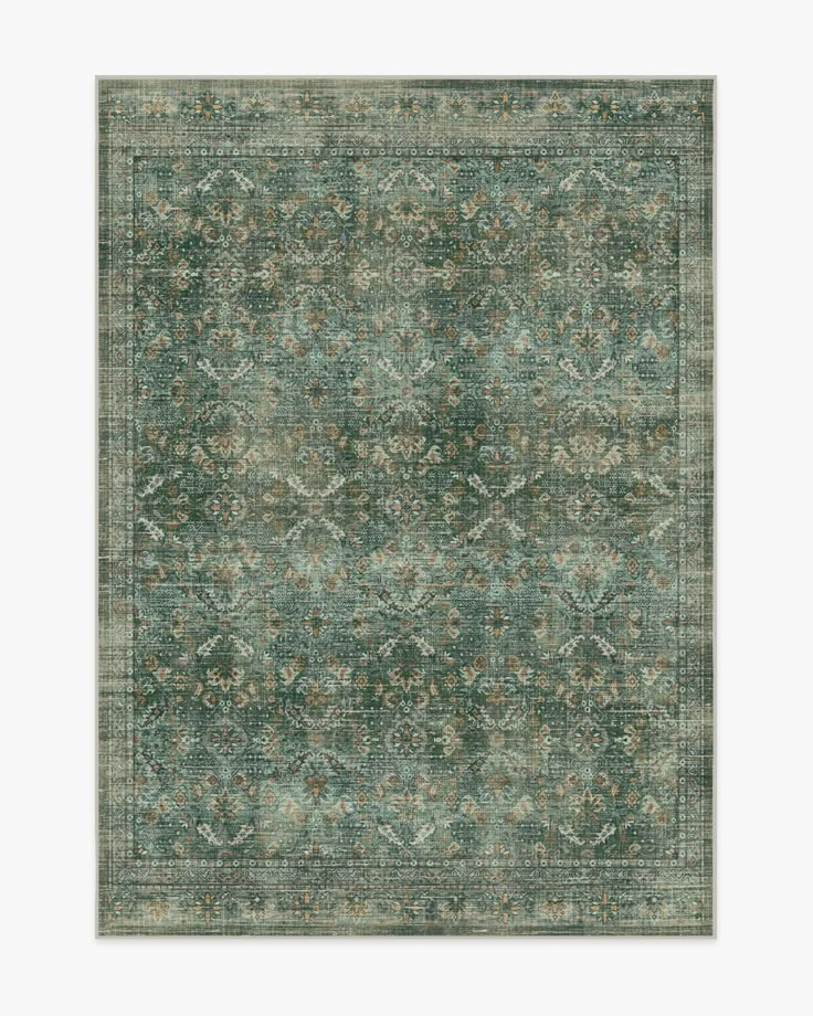 a green rug with an ornate design on the top and bottom, it is very soft