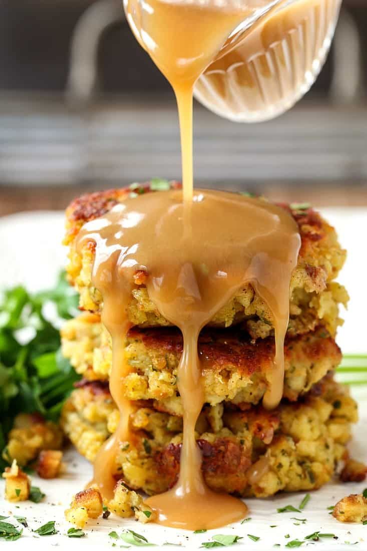 a stack of food with sauce being drizzled over it