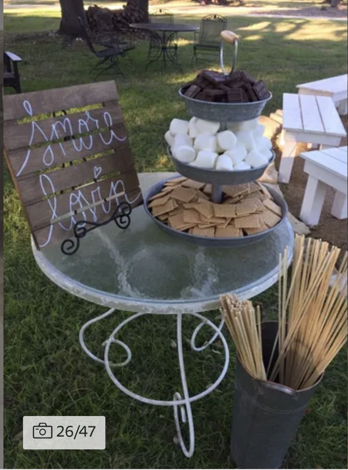 a table that has some food on top of it and a sign next to it