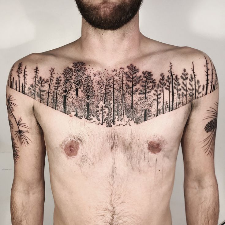 a shirtless man with trees on his chest