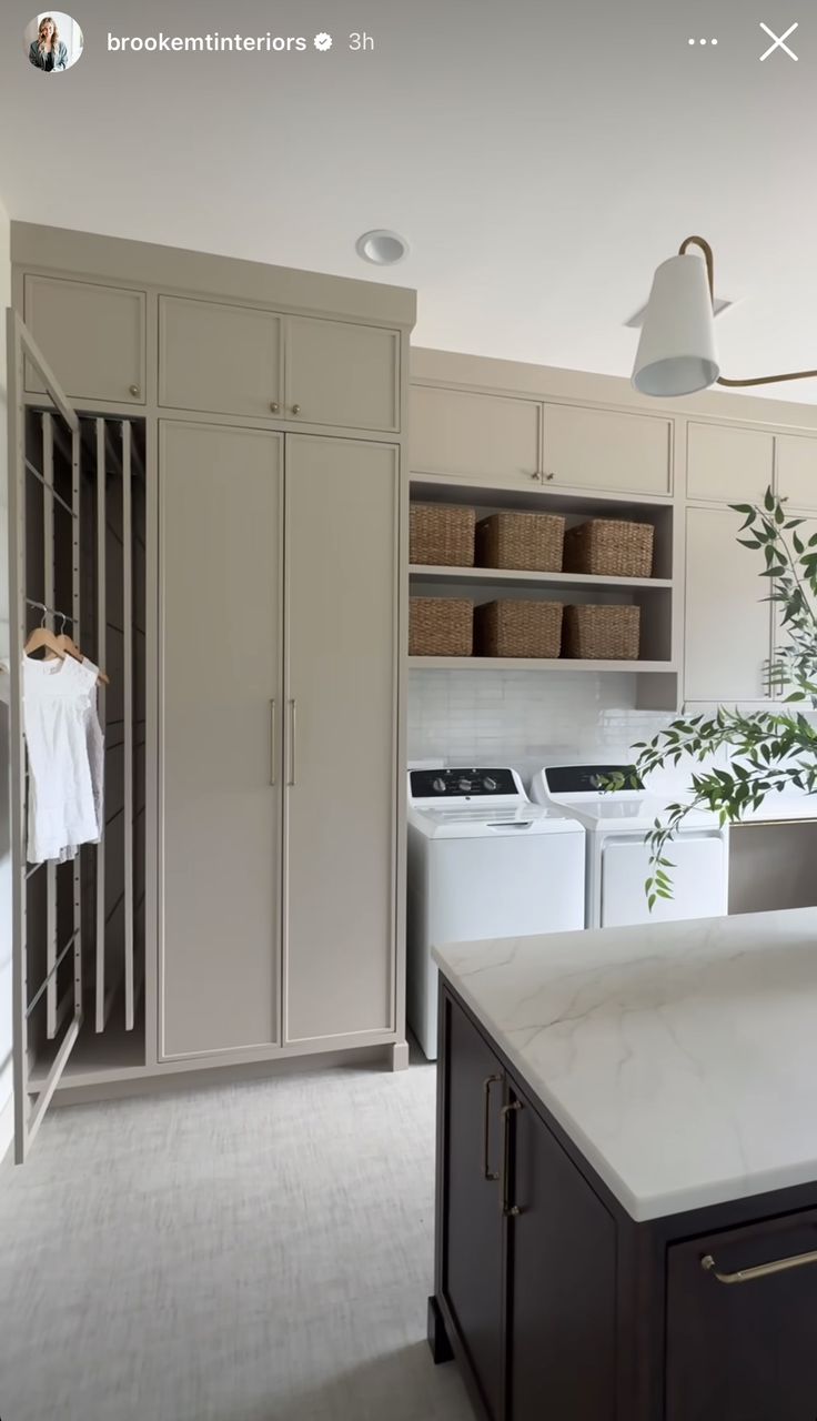 an image of a kitchen setting with cabinets and washer dryer in the foreground