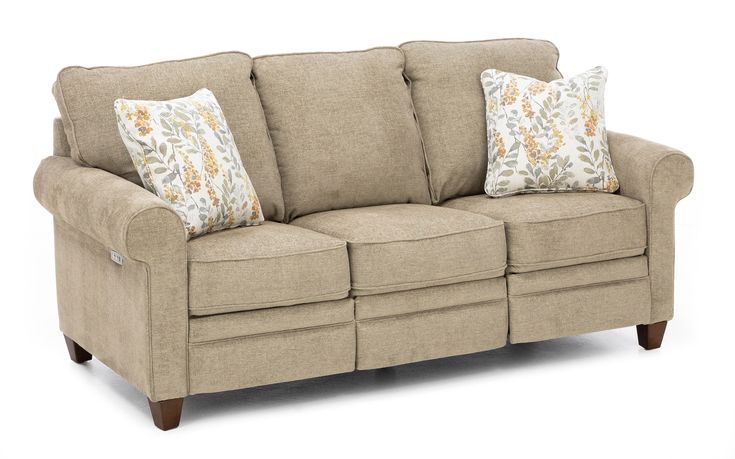 a beige couch with two pillows on it