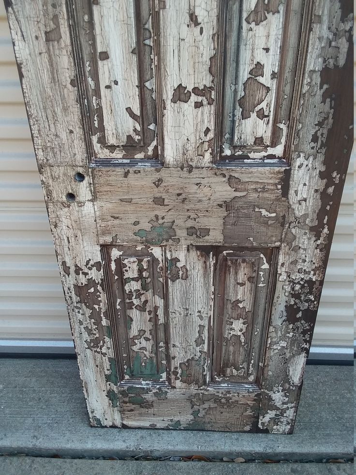 an old door with peeling paint on it