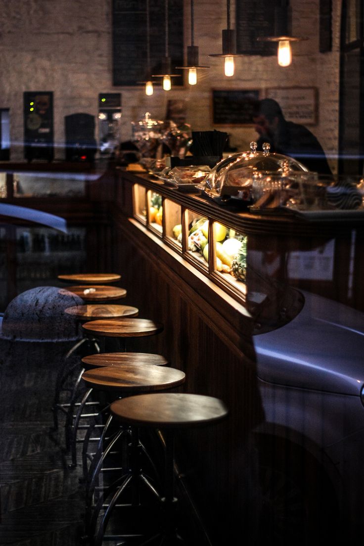 an empty bar with stools in front of it