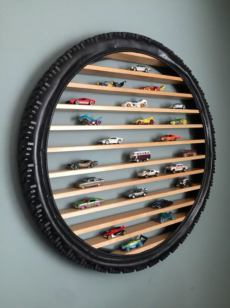 there is a black tire with toy cars on it and some shelves in the middle