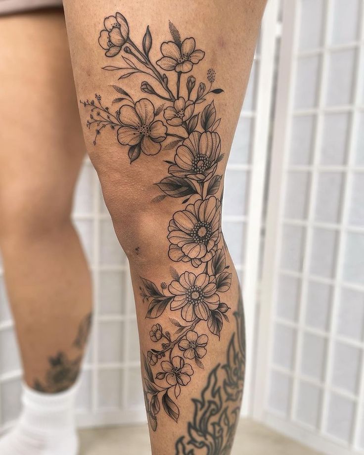 a woman's legs with flowers on them