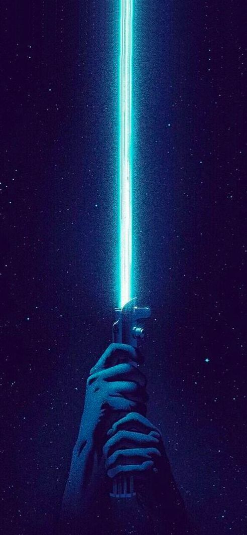 a person holding a light saber in the dark