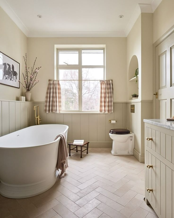 a bathroom with a tub, toilet and sink in it's center piece is shown