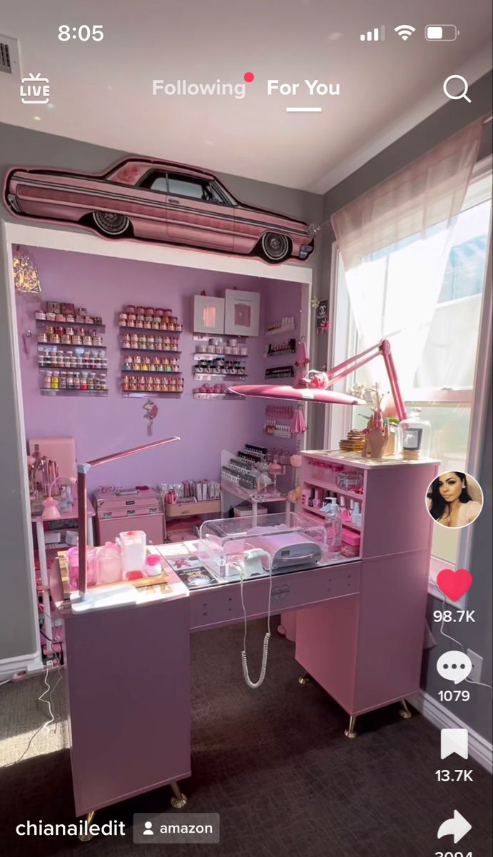 a pink car is parked in front of a purple shop with lots of items on the shelves