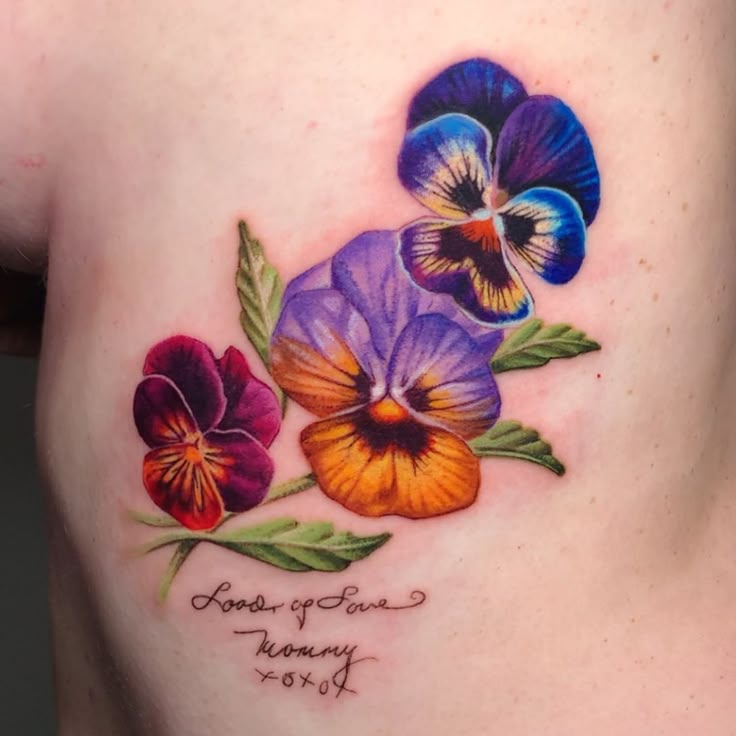 a woman's stomach with three pansies and the words flowers of grace on it