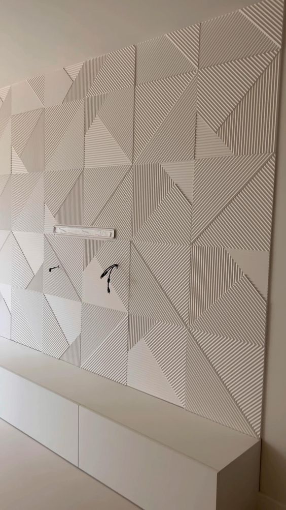 the wall is made up of white geometric shapes and lines, along with an abstract pattern