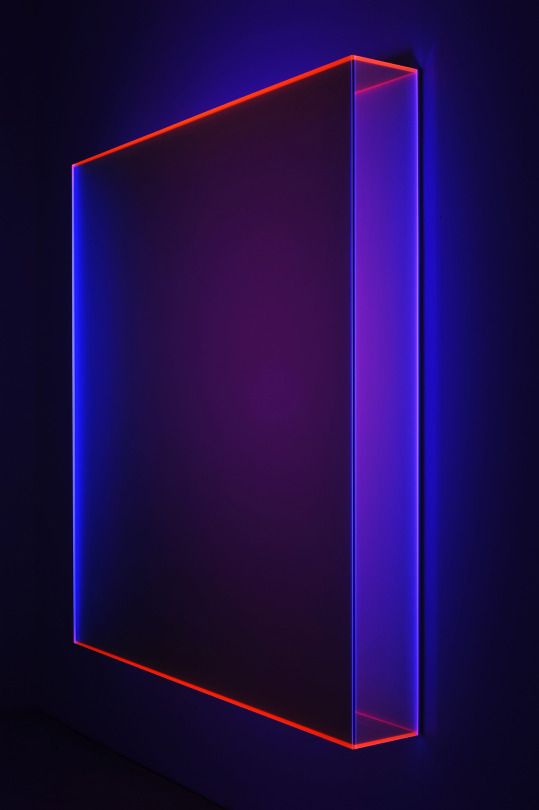 an illuminated cube in the middle of a dark room