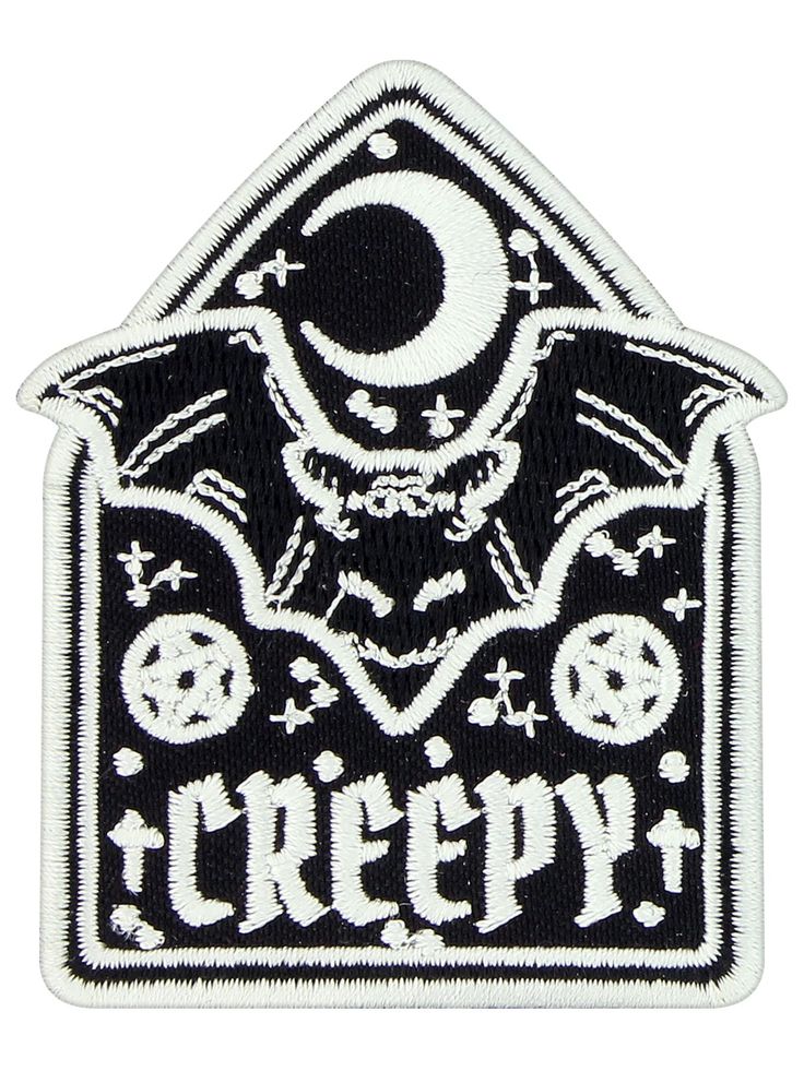 a patch with the word creepy on it and a skull in the middle, surrounded by skulls