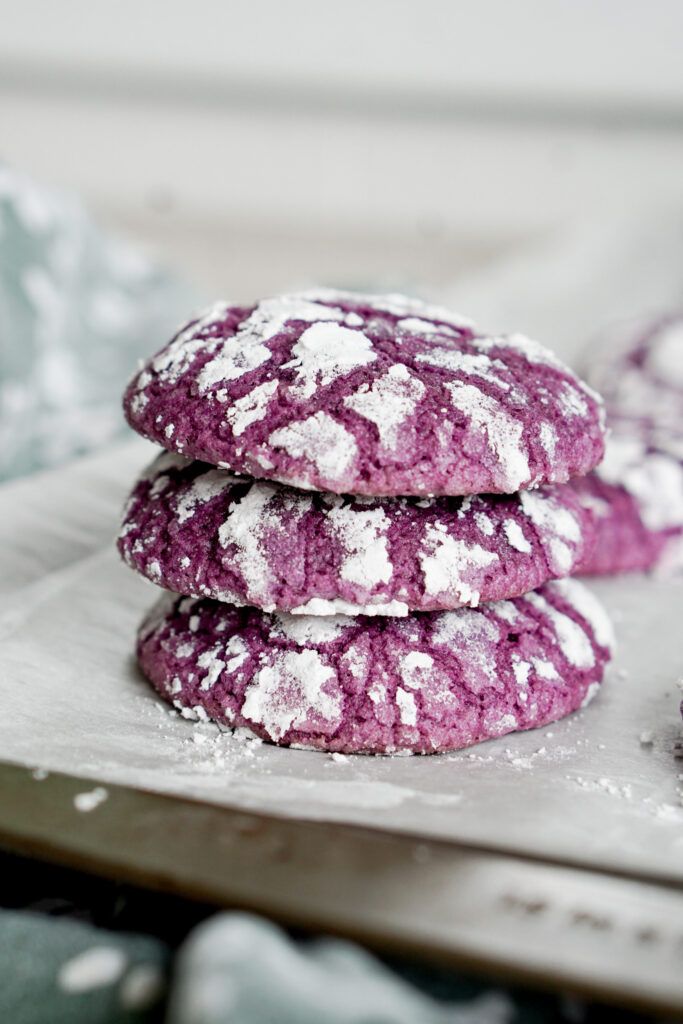 three cookies are covered in powdered sugar