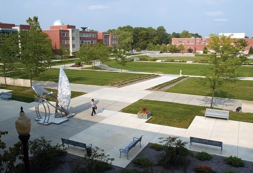 an aerial view of a park with benches and sculptures