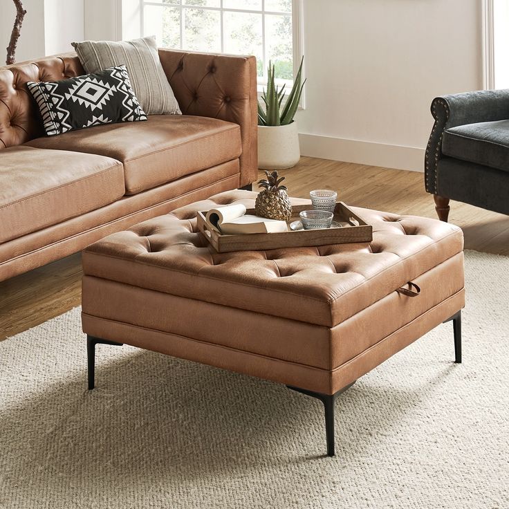 a living room with two couches and a coffee table in front of a window