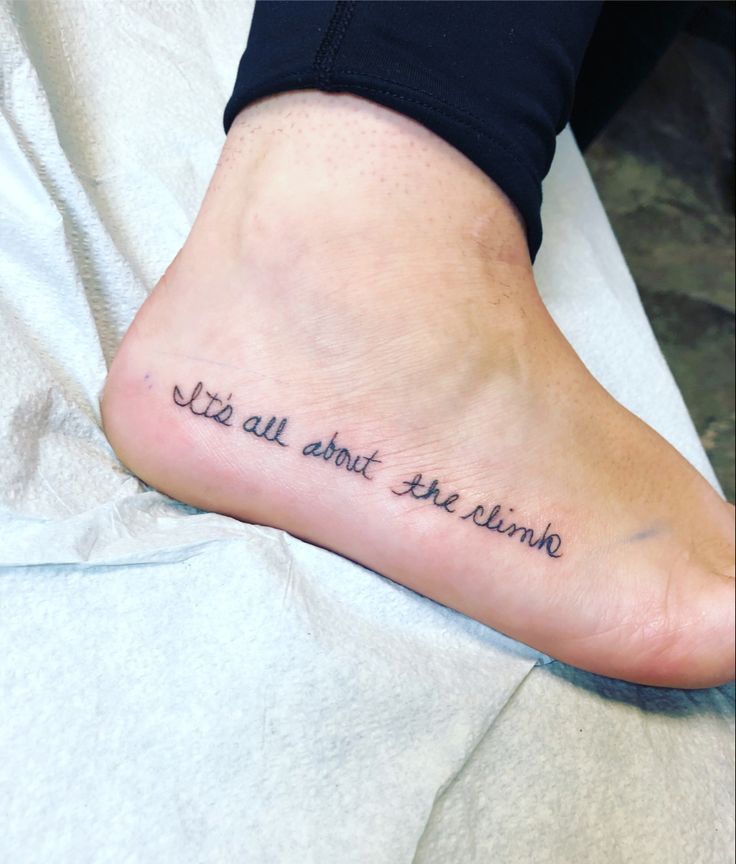 a person with a tattoo on their foot that says, life is all about art