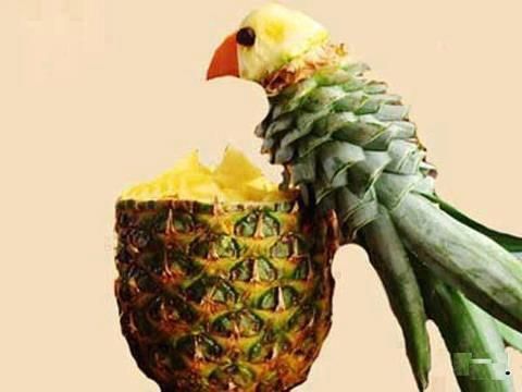 a bird sitting on top of a pineapple