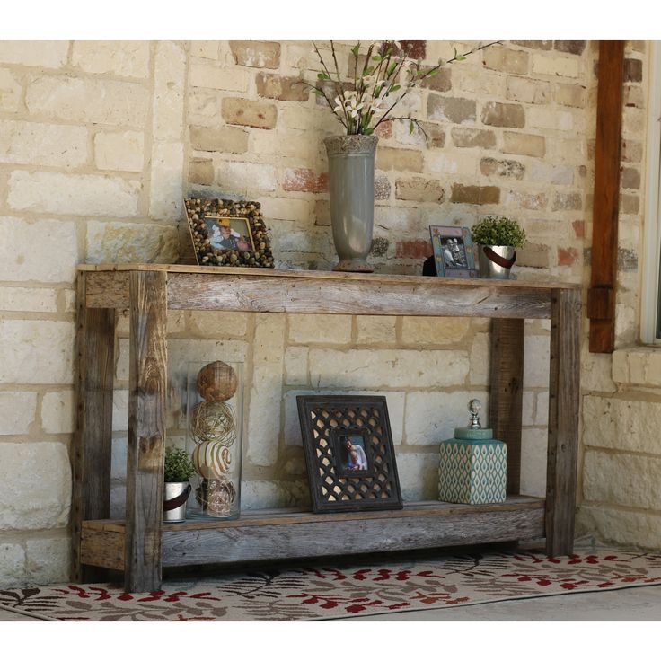 a wooden shelf sitting next to a brick wall