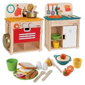 a wooden toy kitchen set with food and utensils