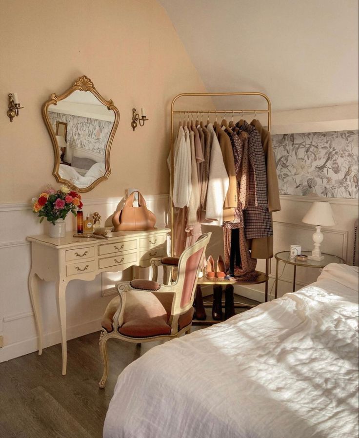 a bedroom with a bed, dressing table and mirror on the wall next to it