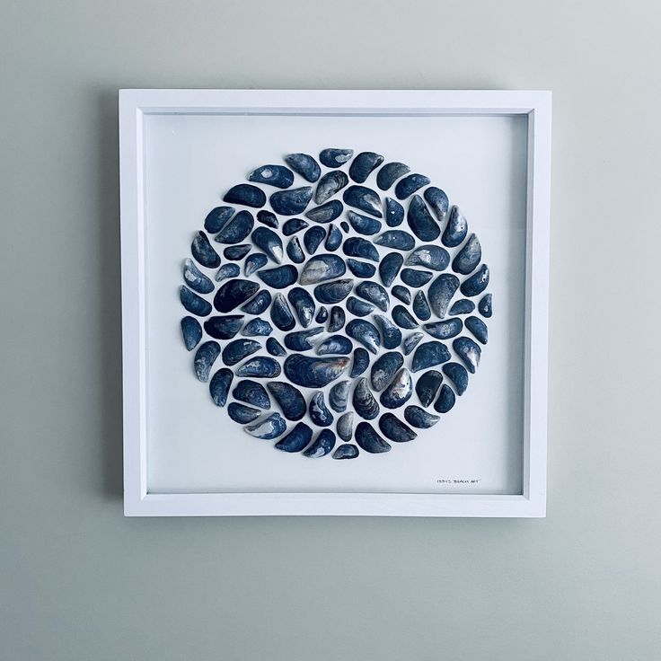 a white frame with some rocks in it