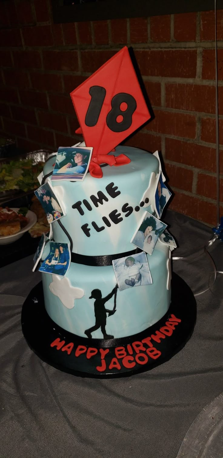 a birthday cake with an image of a man holding a kite on top of it