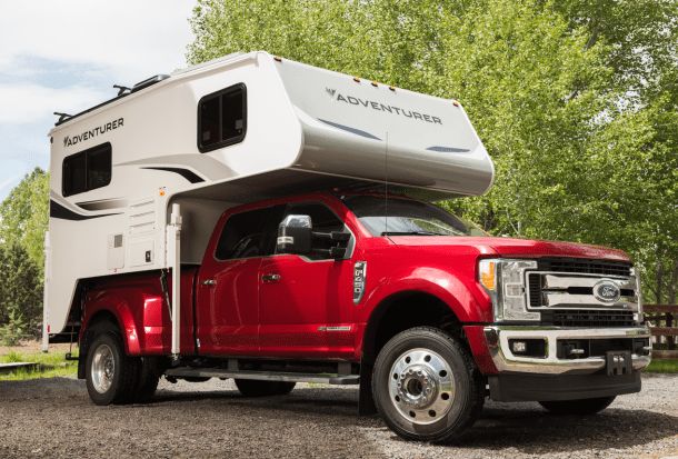 a red truck with a camper attached to it