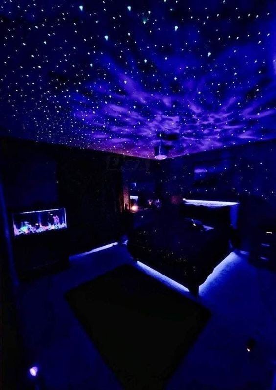 a room with blue lights and stars on the ceiling