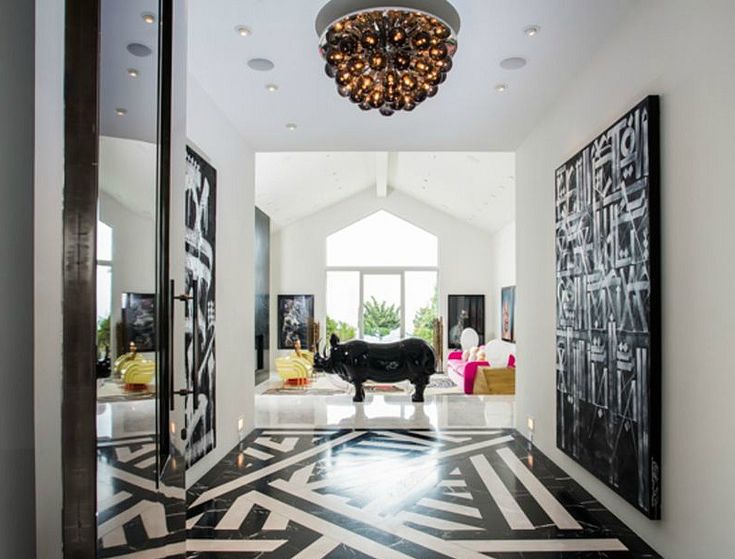 a black and white floor with an animal statue in the center, surrounded by art