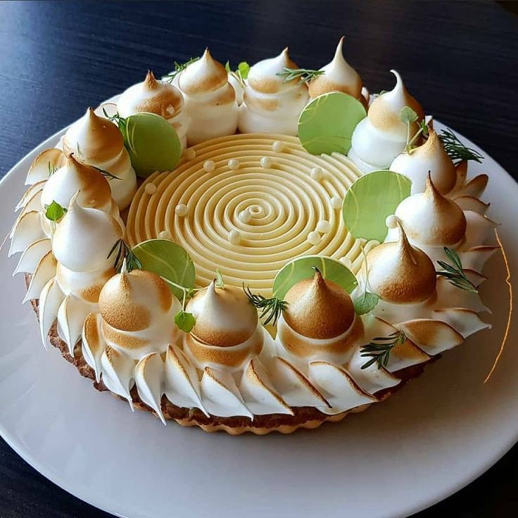 a cake with white frosting and green leaves on top is shown in an instagram