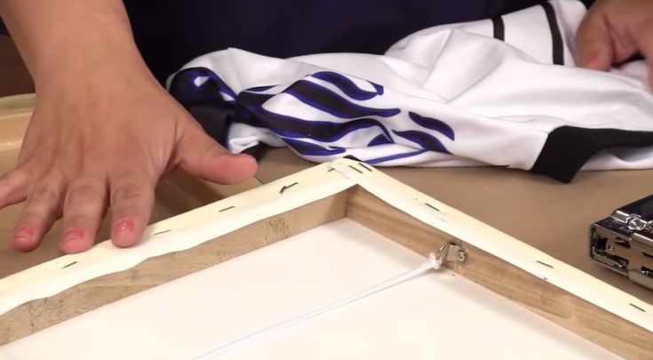 a person is working on something that looks like an open box with the lid closed