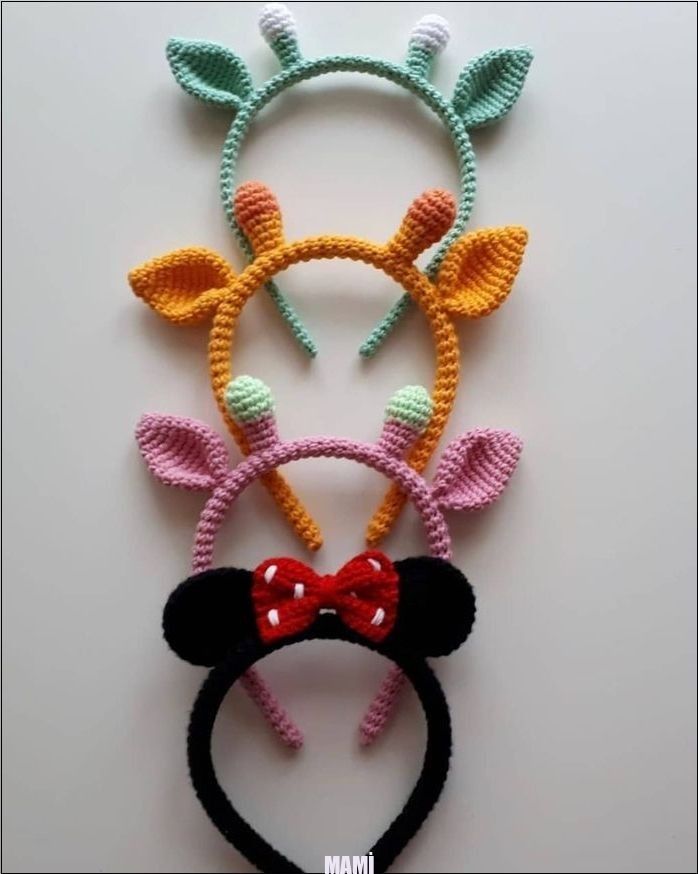 three crocheted headbands with ears and bows on top of each other