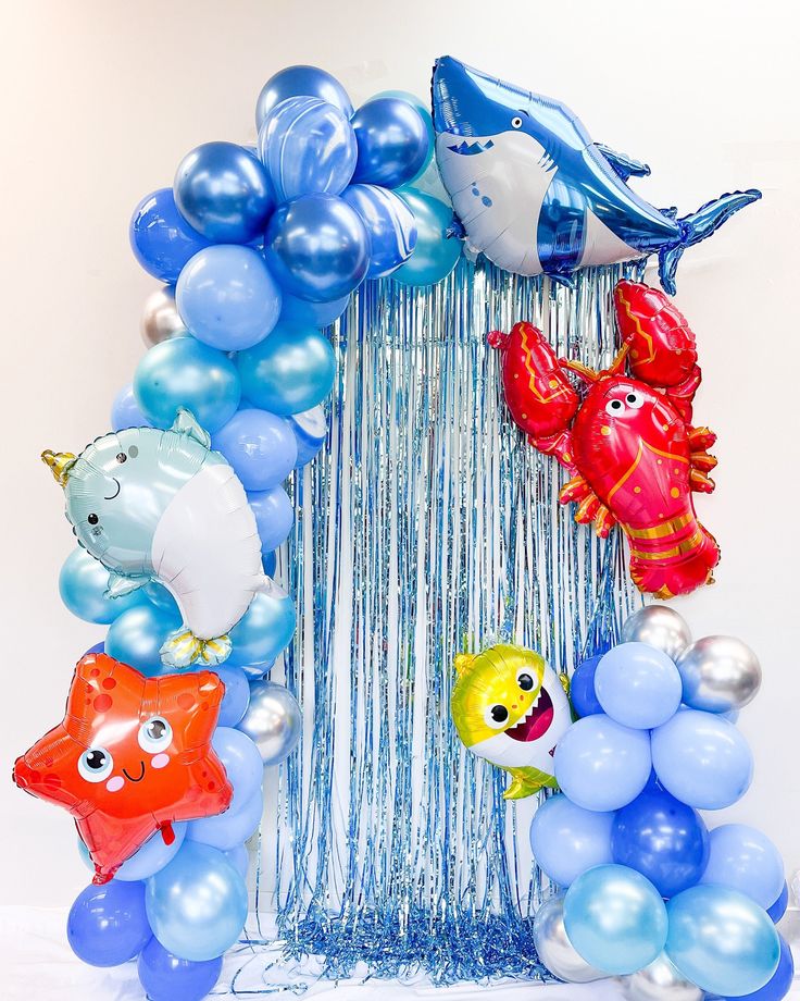 a bunch of balloons that are in the shape of a house with sea animals on it