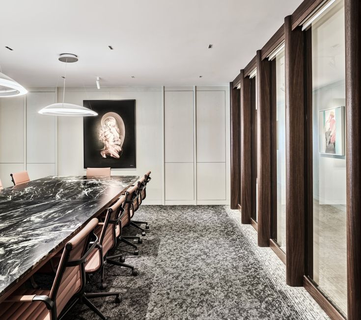 an empty conference room with marble table and chairs