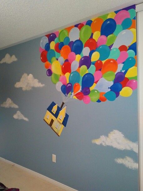 a child's room with a large balloon painted on the wall and a door