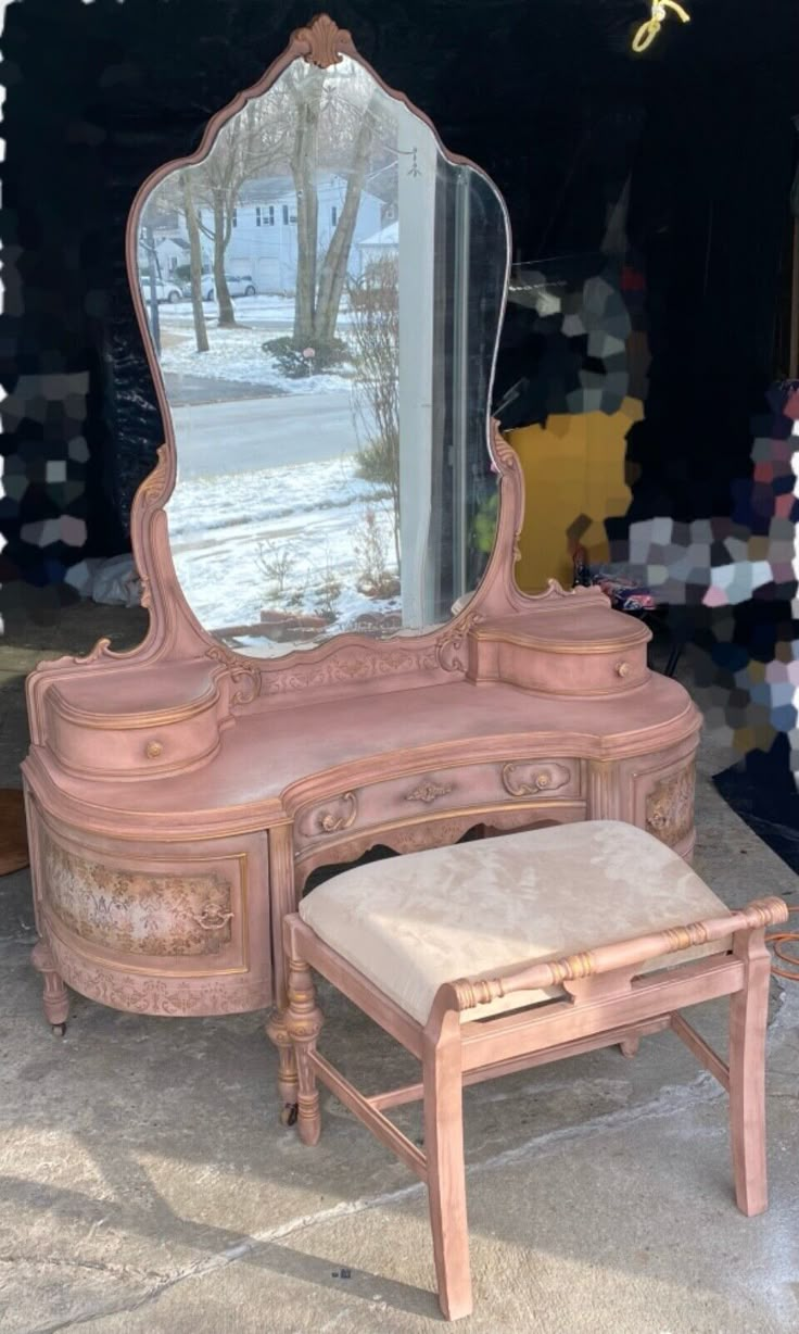 an antique vanity with mirror and stool in front of it