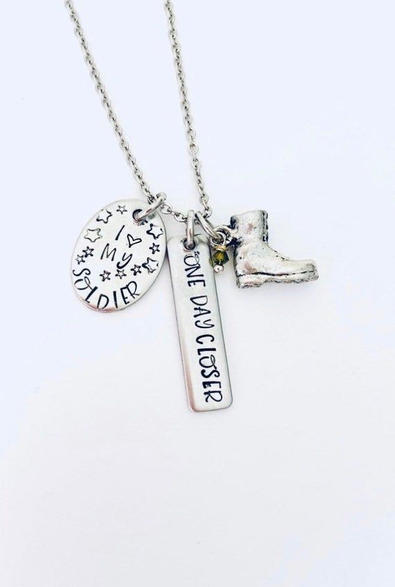 a silver necklace with two charms on it