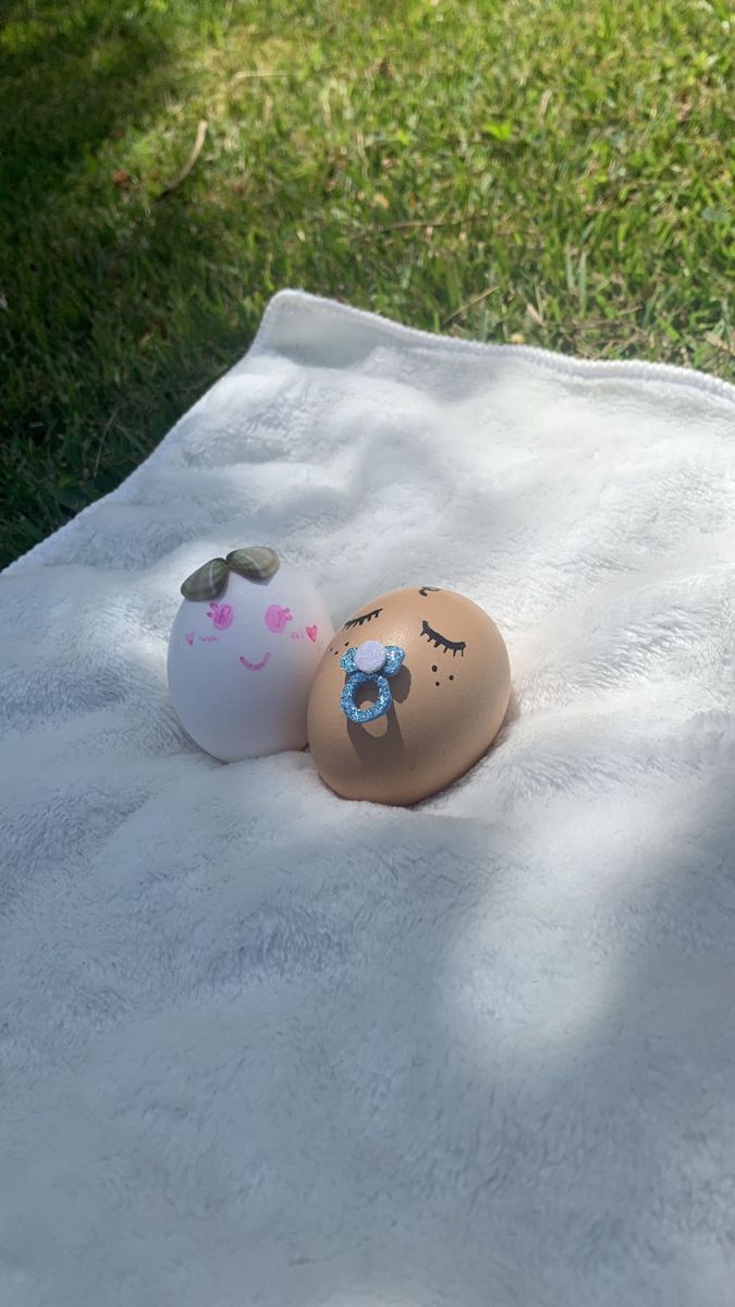 two eggs sitting on top of a white blanket