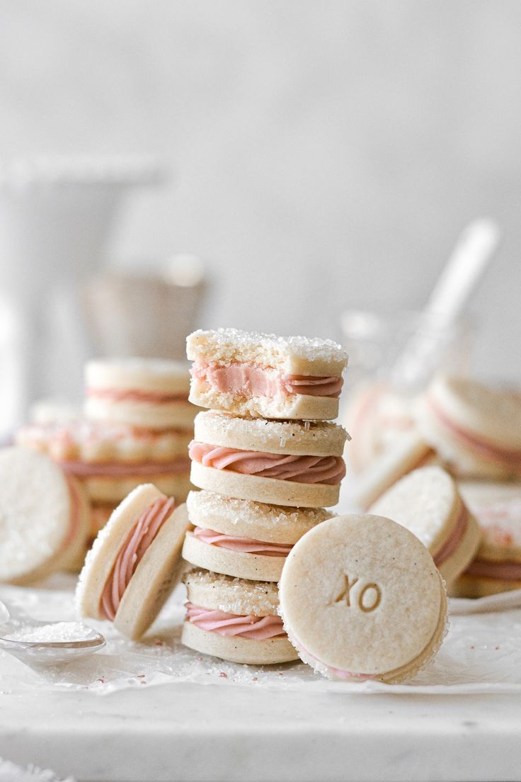 a stack of cookies with pink and white frosting