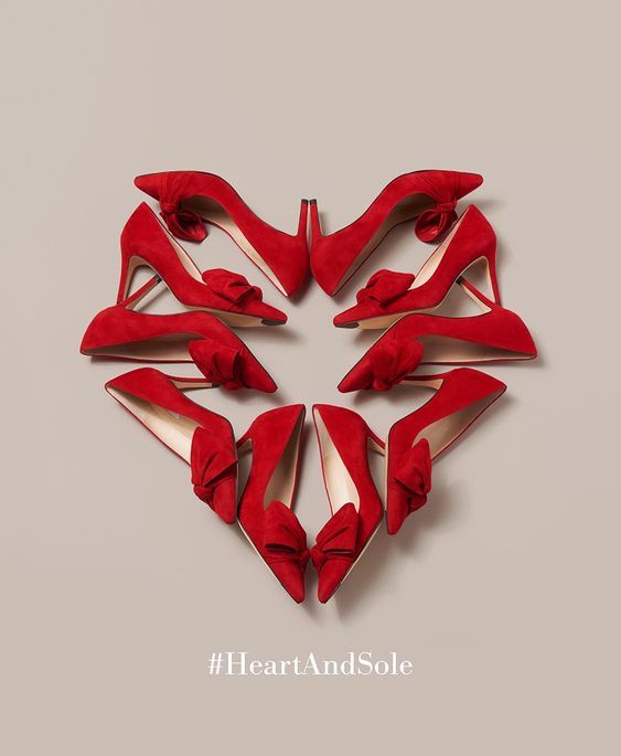 red high heeled shoes arranged in the shape of a heart on a website page